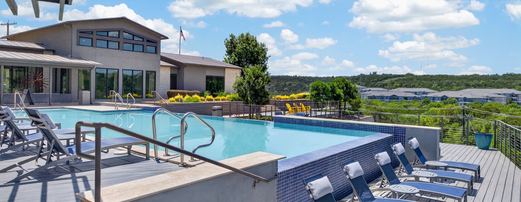 a swimming pool with chairs around it