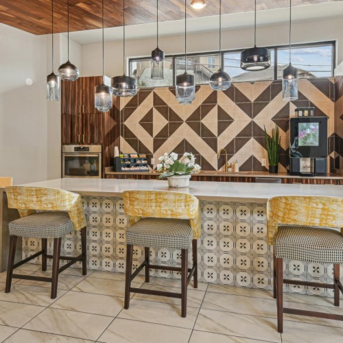 a kitchen with a bar and chairs