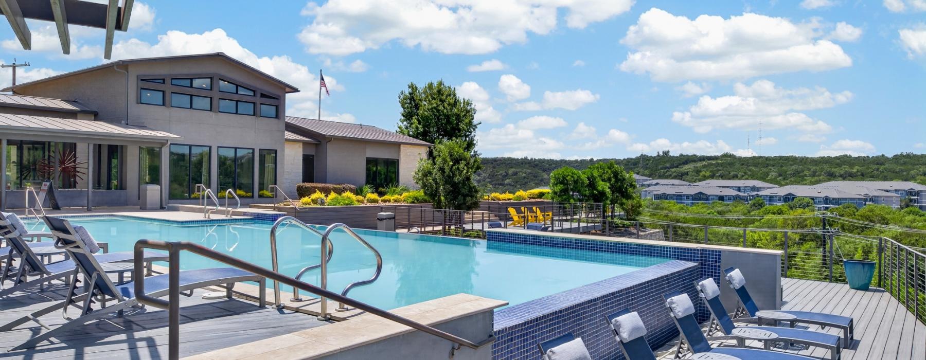 a swimming pool with chairs around it