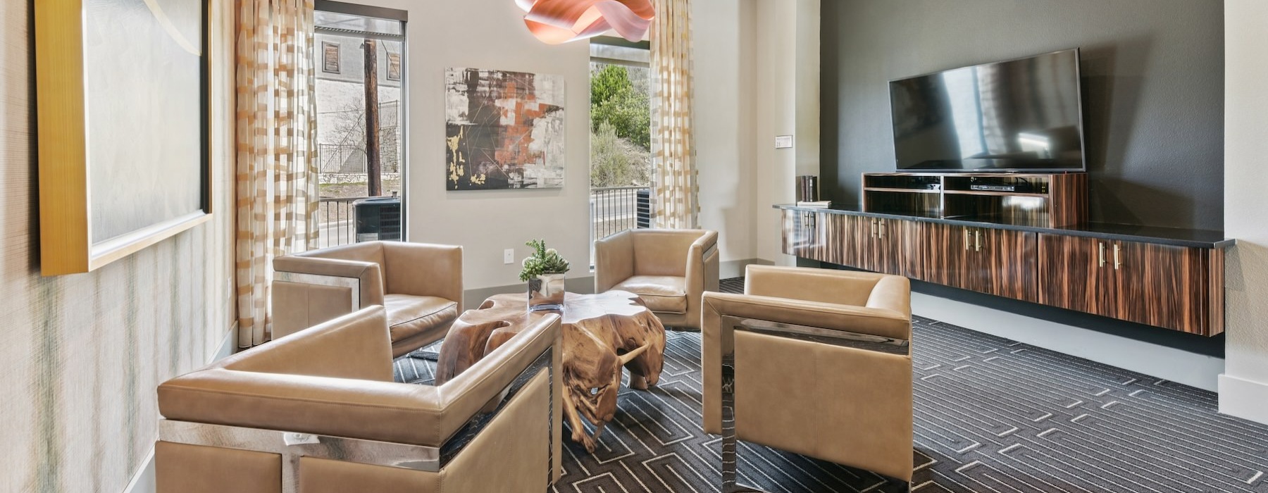 a clubroom with chairs, tables and a tv