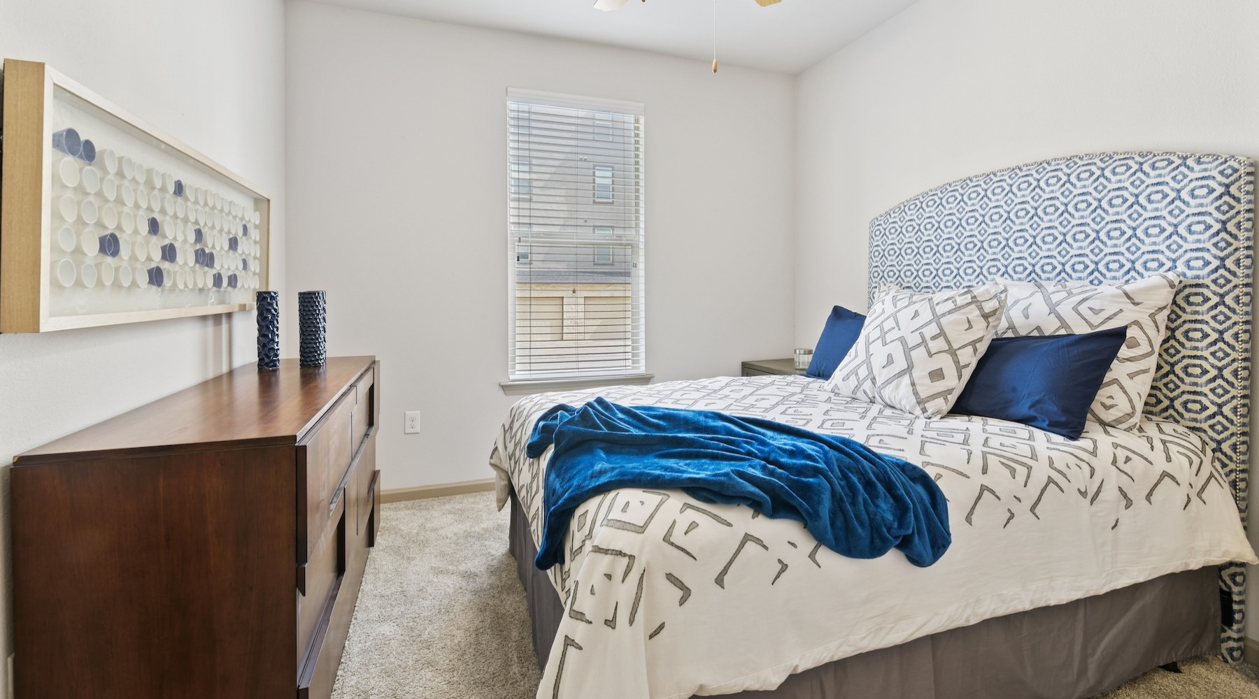 a bedroom with a bed and a dresser